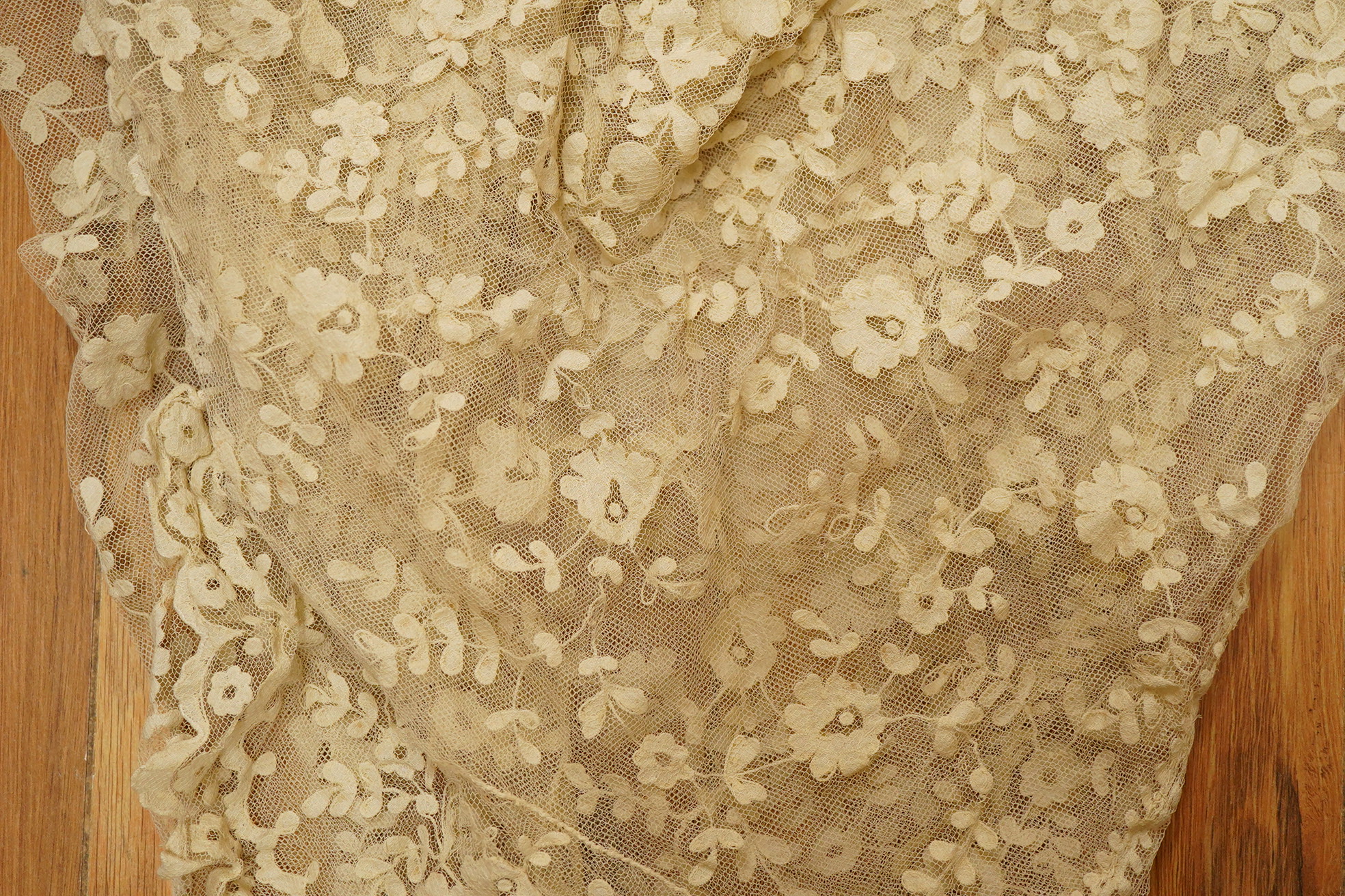 An Irish late 19th, Carrick Cross, Irish lace ladies shaped cape with collar, 200cm wide x 88cm long. Condition - a few dark rust stains and slight catches to net, but mainly in good condition.